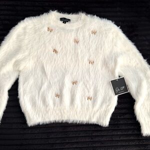 Chic White Fuzzy Sweater with Gold Bow Accents Medium